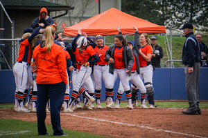Hannah Dossett steps on home and is greeted by her teammates after hitting a home run against Virginia Tech on May 1. 