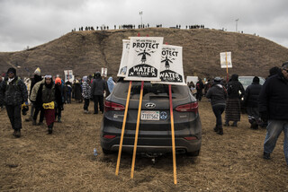 The art tent screen printed signs of solidarity, pictured here, used during direct action to remind both protectors and police that they are peaceful.