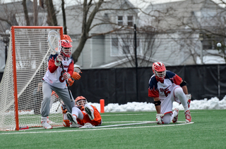 A Syracuse player dives in front of Costa. 