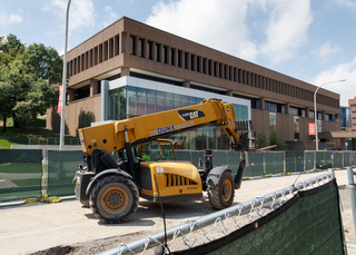 Construction equipment drives down Waverly Avenue, in front of the Newhouse 2 building, as work continues on a sewer line upgrade project. Work is expected to be completed in August. Photo taken July 18, 2017